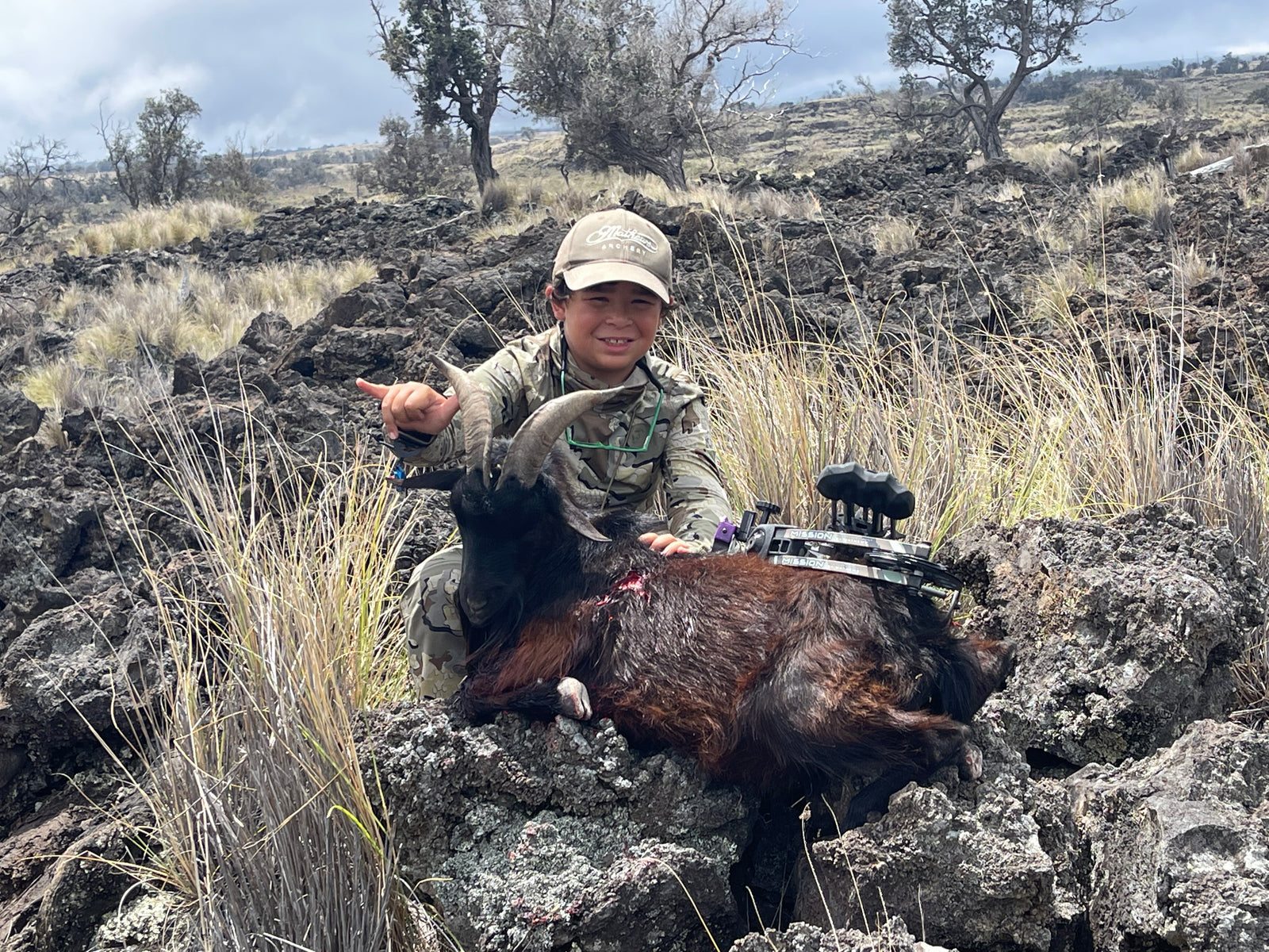 child posing for a photo with crossbow