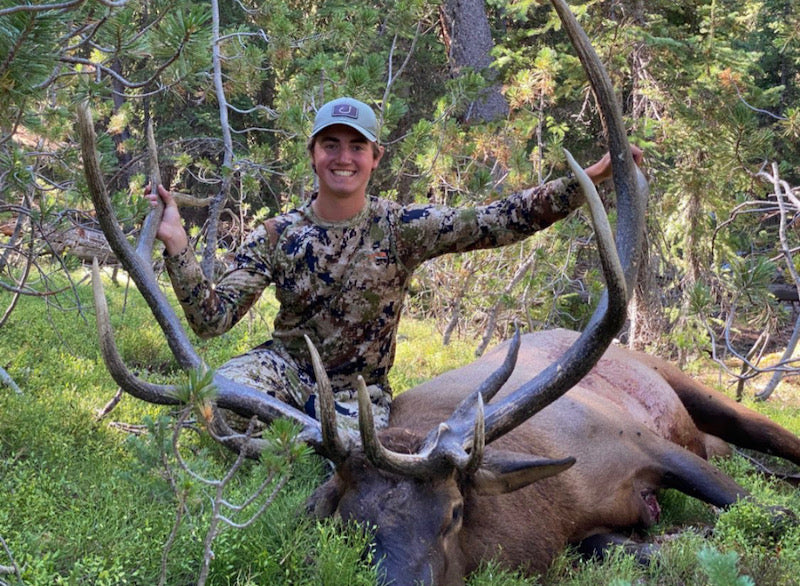 woman posing with deer after hunting