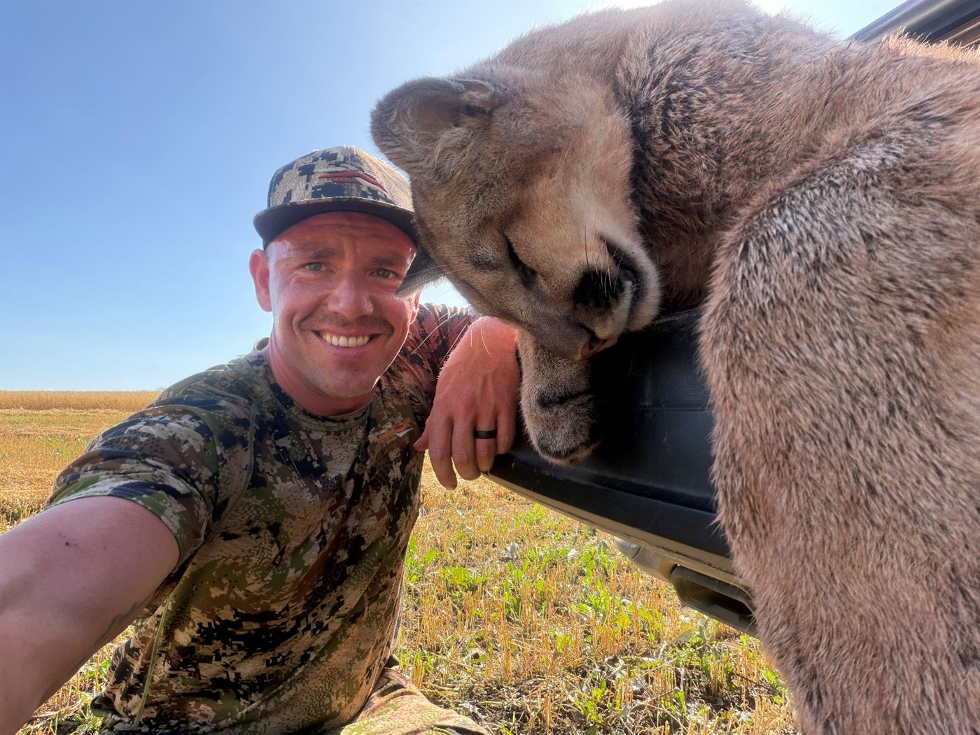 Jake smiling beside the cougar he took with a Katana broadhead